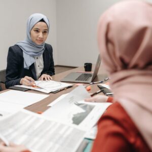 Image of two women in hijab in a website planning meeting
