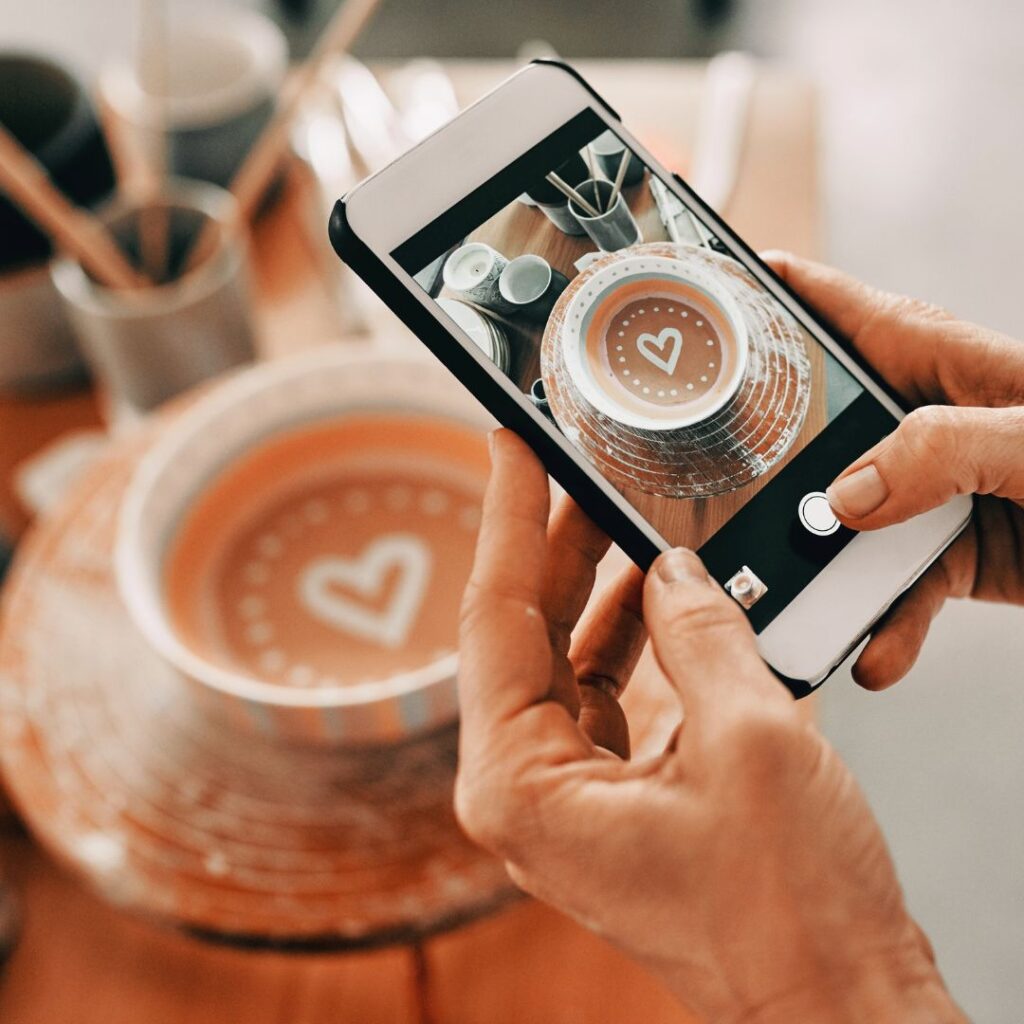 Image of taking a photo of pottery on an iphone